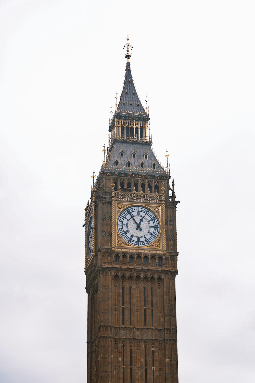 a tall clock tower with a clock on each of it's sides