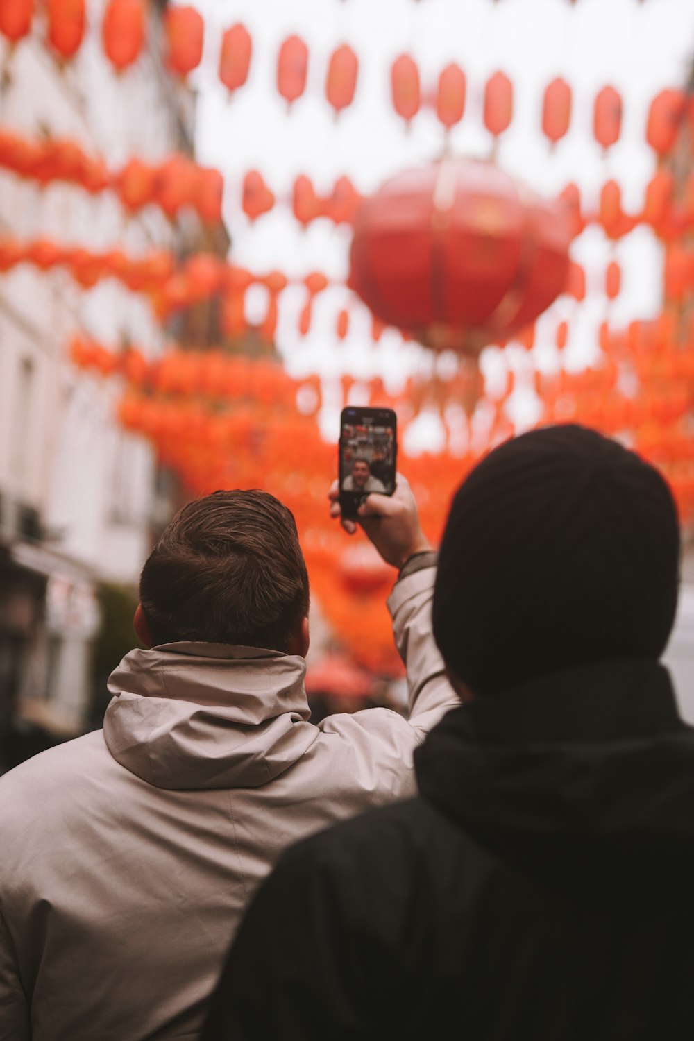 a man and a woman taking a picture with a cell phone