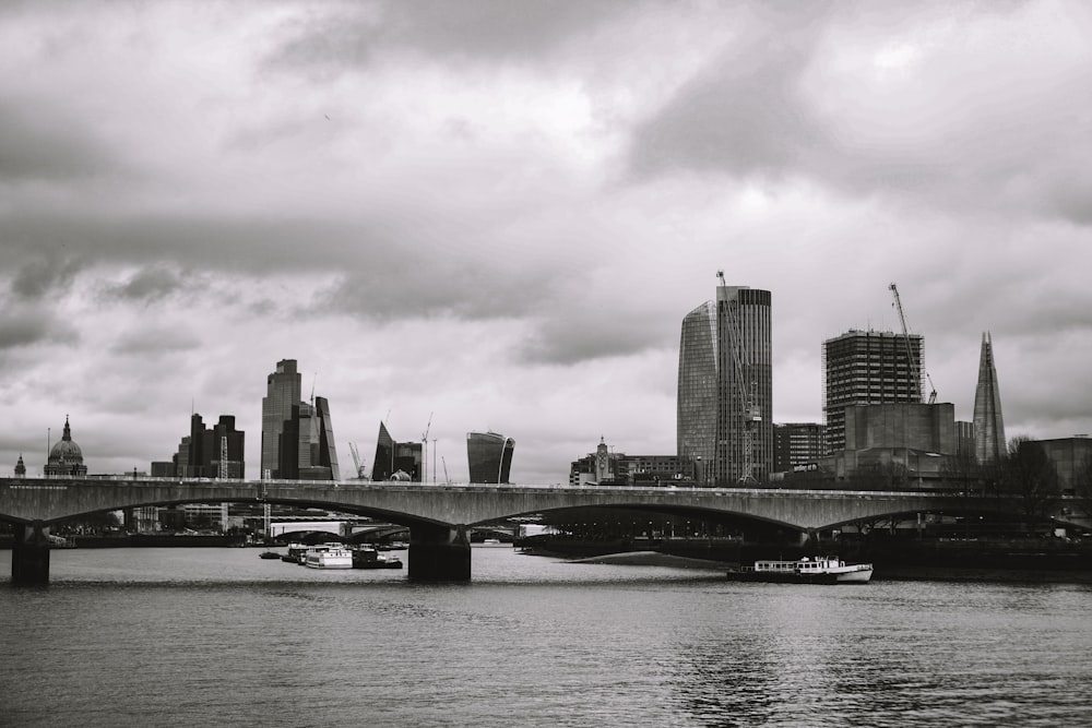 a black and white photo of a bridge over a river