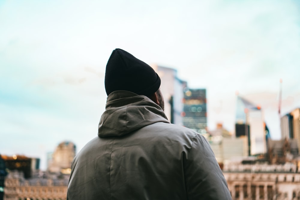 a man standing in front of a city skyline