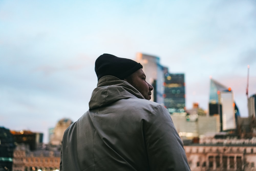 a man standing in front of a city skyline