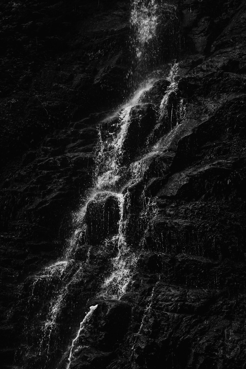 a black and white photo of a waterfall