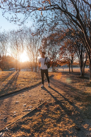 A person jogging in a park during sunrise, symbolizing health and energy.