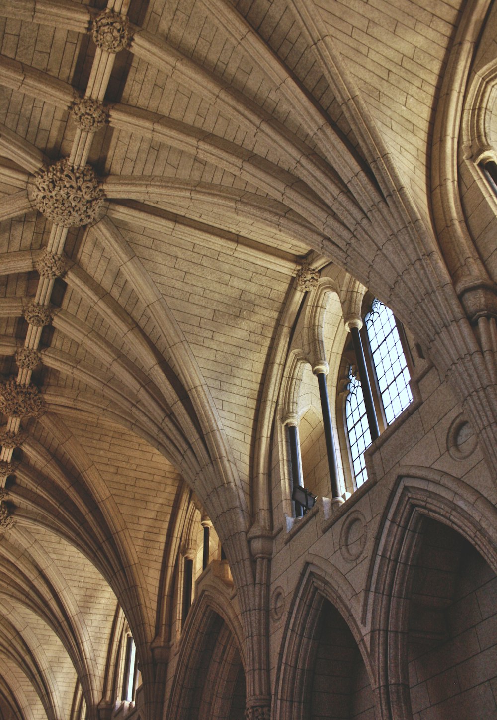 the ceiling of a large cathedral with a clock on it