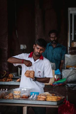 a man standing in front of a table filled with food