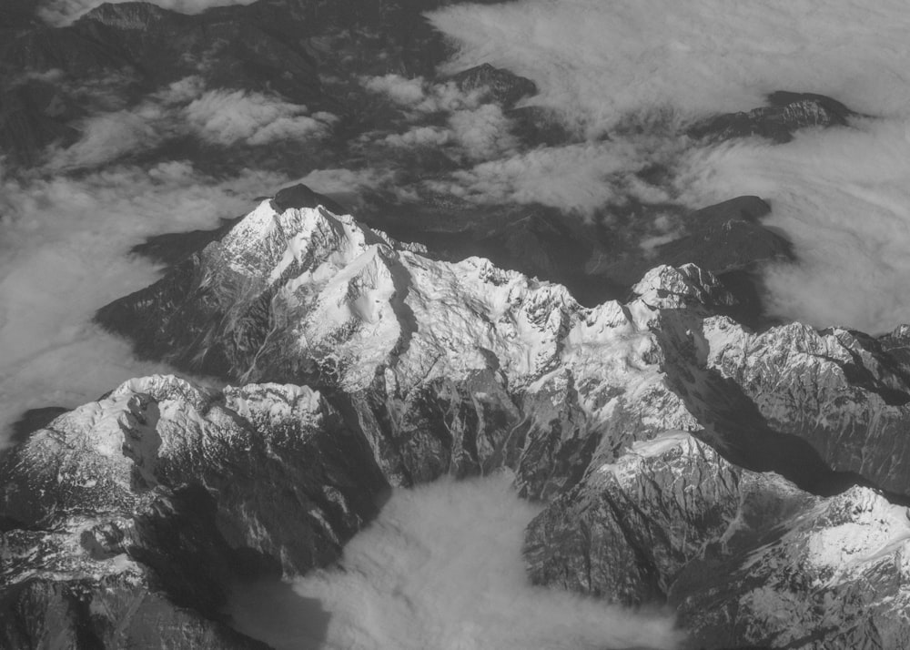 a black and white photo of snow covered mountains