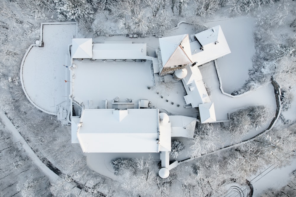 an aerial view of a house in the snow