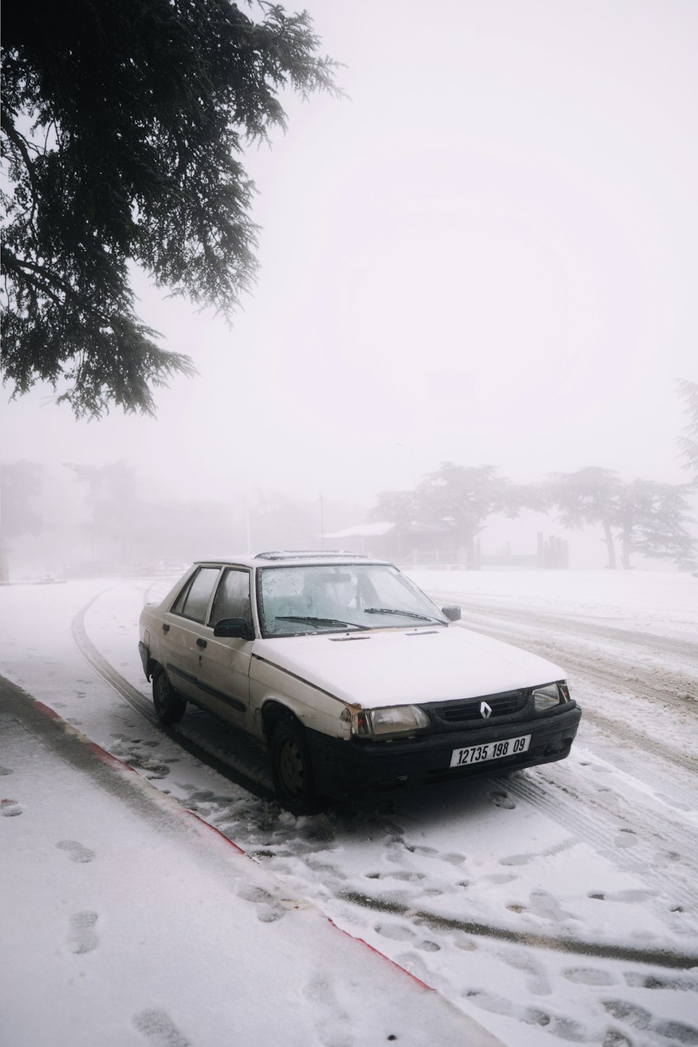 a car parked on the side of a snowy road