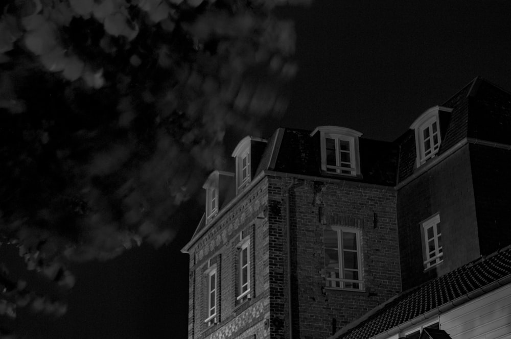 a black and white photo of a building at night