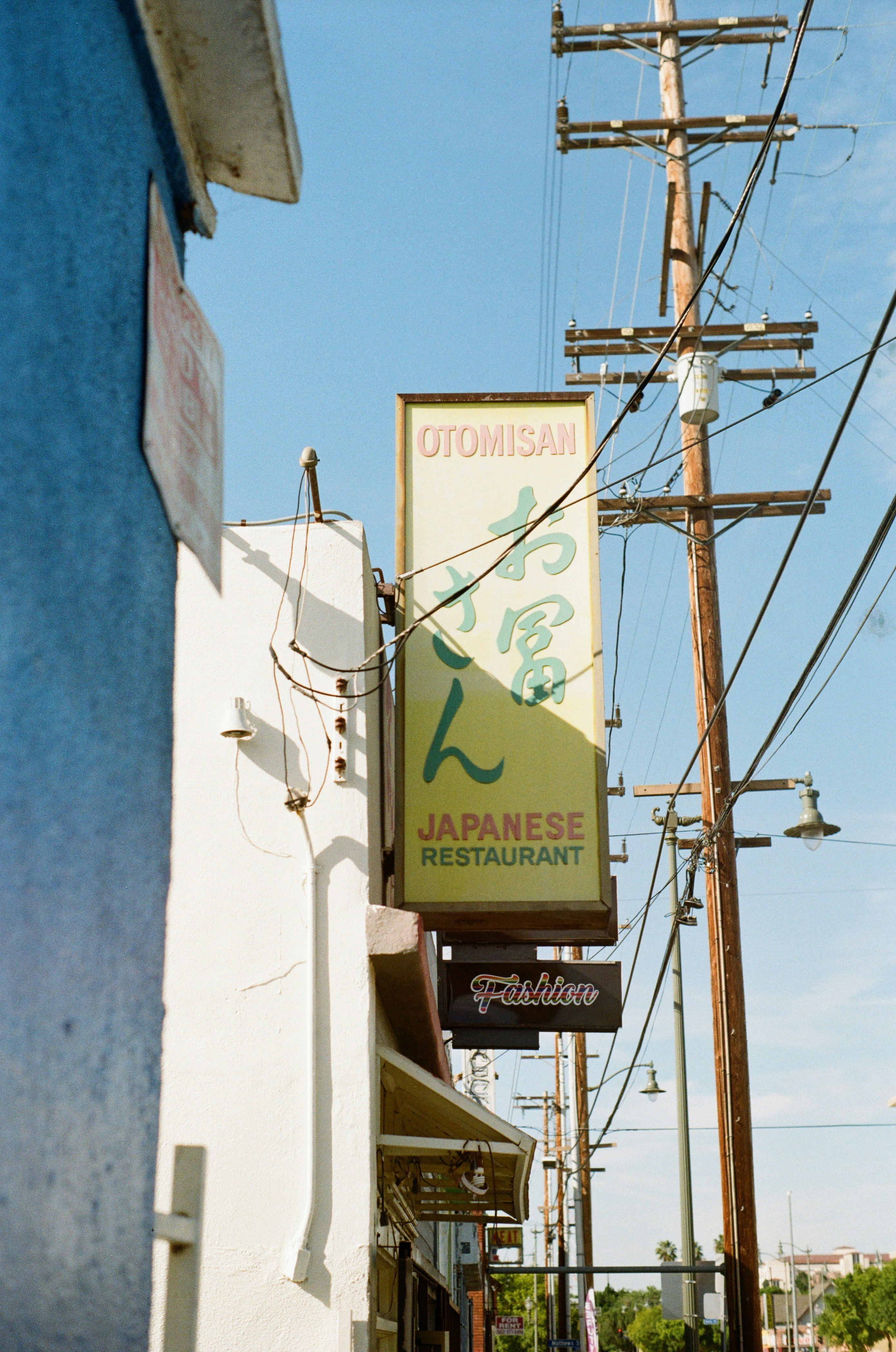 a sign for a japanese restaurant on a city street