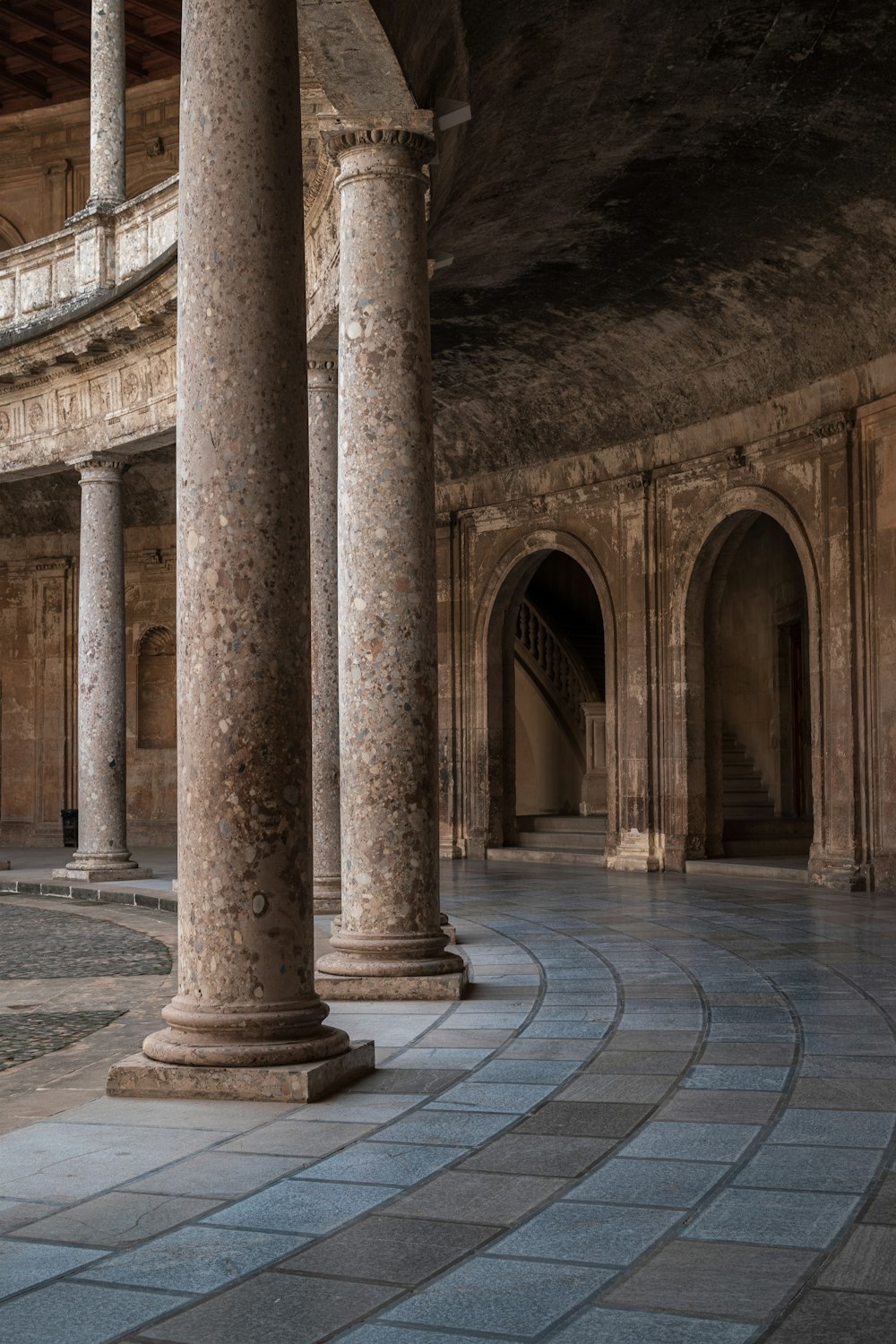 a large room with columns and a clock on the wall