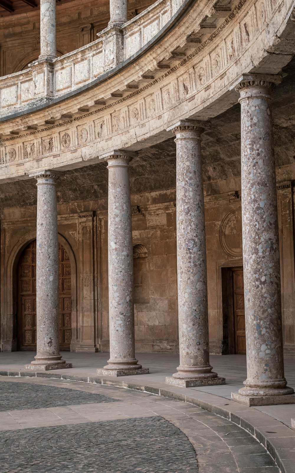 a large building with columns and a clock on the wall