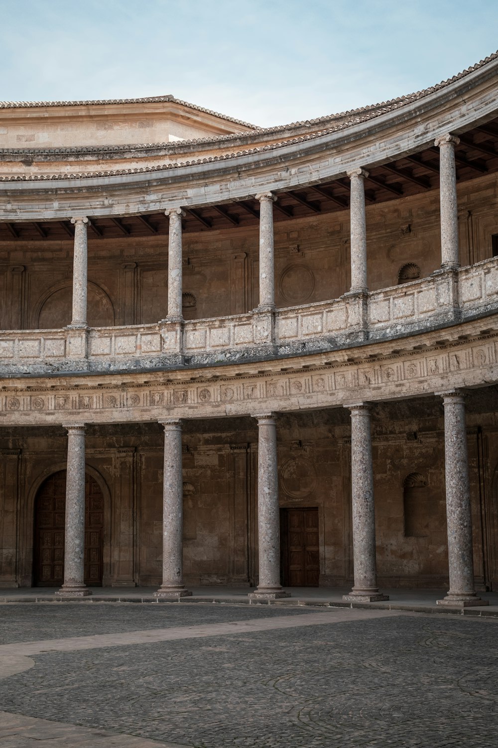 a circular building with columns and arches