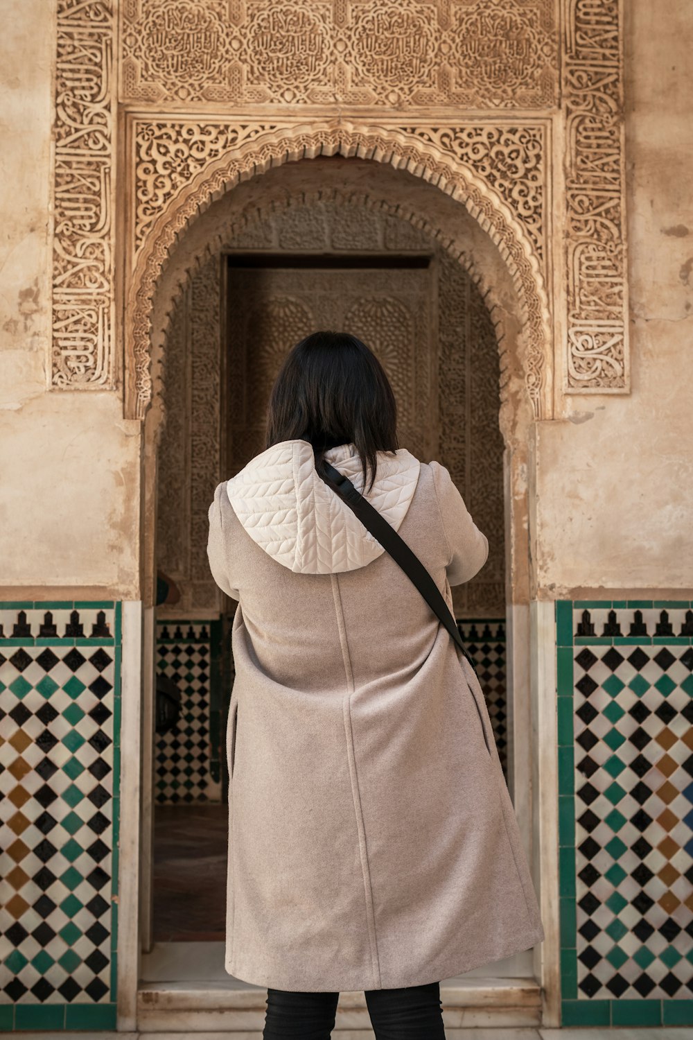 a woman standing in front of a doorway