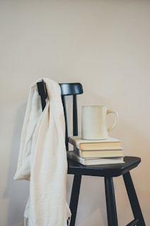 A cozy striped scarf draped over a wooden chair.