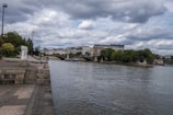 The Seine river flowing gently beside the Cheval Blanc hotel, with the Left Bank in the background.