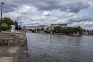 The Seine river flowing gently beside the Cheval Blanc hotel, with the Left Bank in the background.
