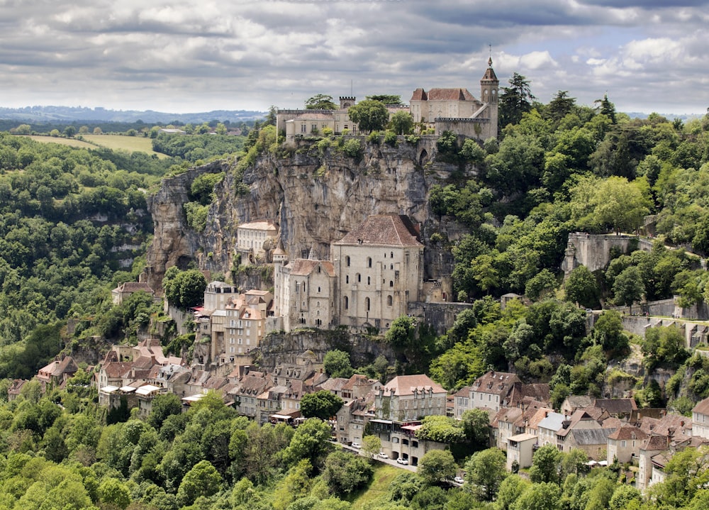 a village on a hill surrounded by trees