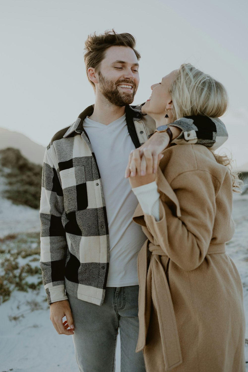 a man and a woman standing in the snow