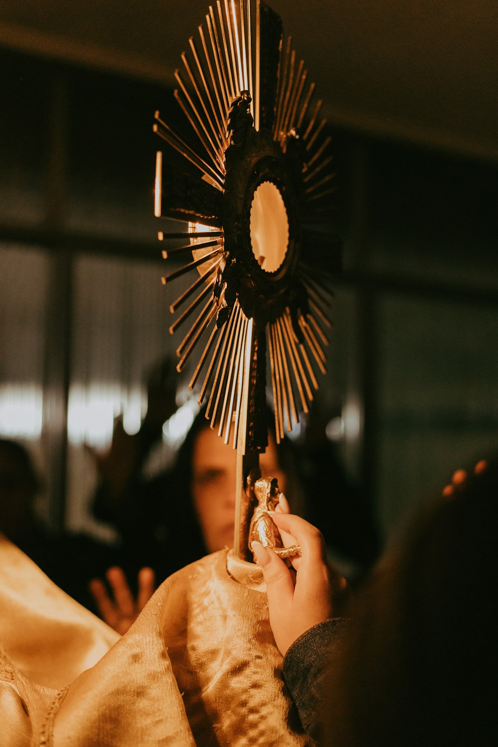 a close up of a person holding a cross