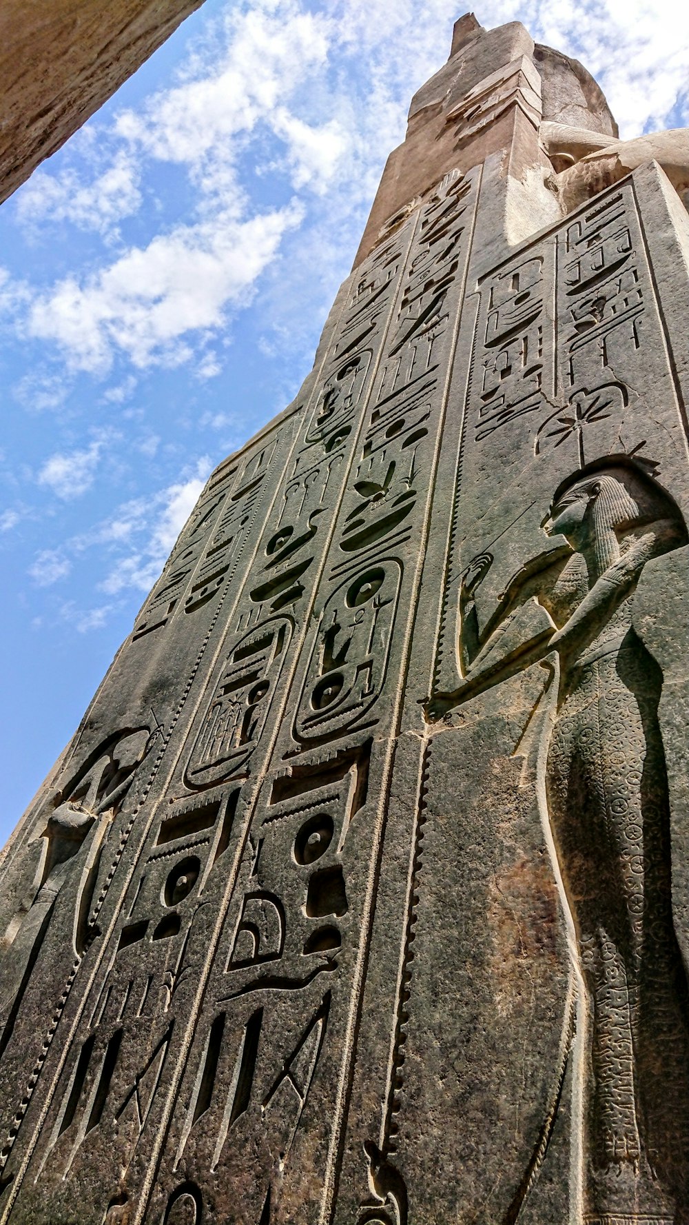 a tall stone tower with egyptian writing on it