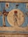 An ancient Egyptian carving depicting a deity figure holding a staff, set against a circular background. The figure is accompanied by another figure with a headpiece, both presented in traditional Egyptian attire and art style. Vibrant colors like red and blue accentuate the image, and hieroglyphic motifs decorate the surrounding space.