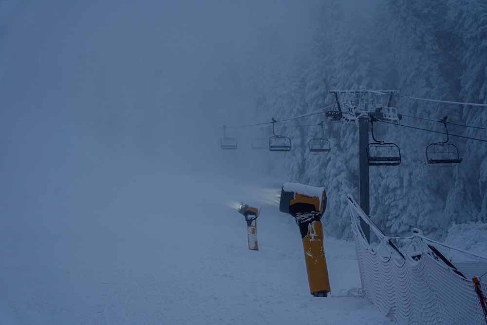 a snow covered ski slope with a ski lift in the background