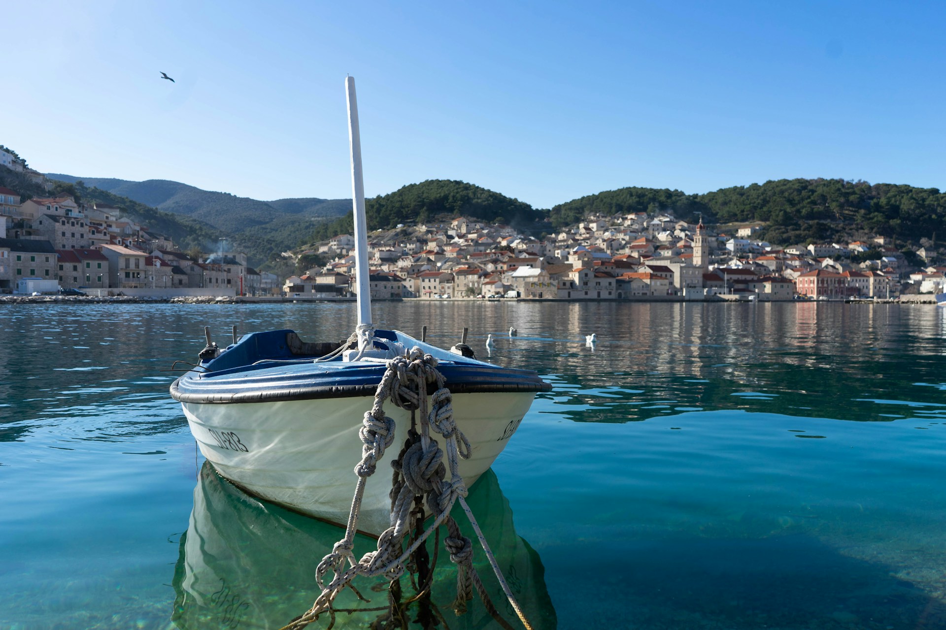 a small boat tied to a dock in the water