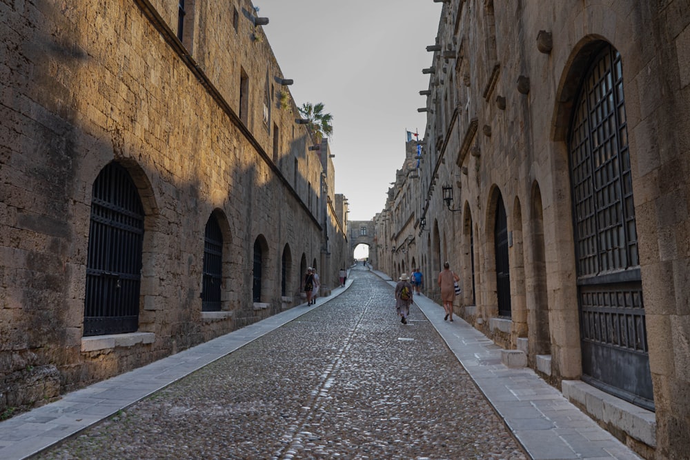 a cobblestone street lined with stone buildings