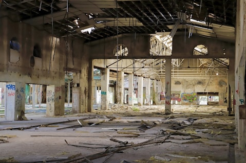 an abandoned building with a lot of debris on the floor