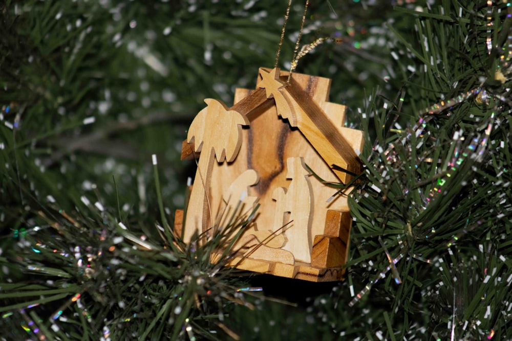 a wooden ornament hanging from a christmas tree