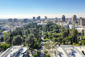Aerial view of a modern city with green spaces.