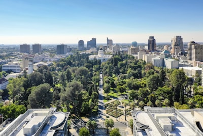 Aerial view of a modern city with green spaces.