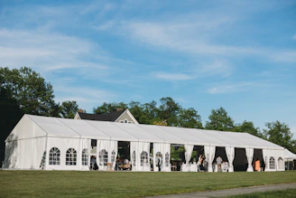 a large white tent set up for a wedding