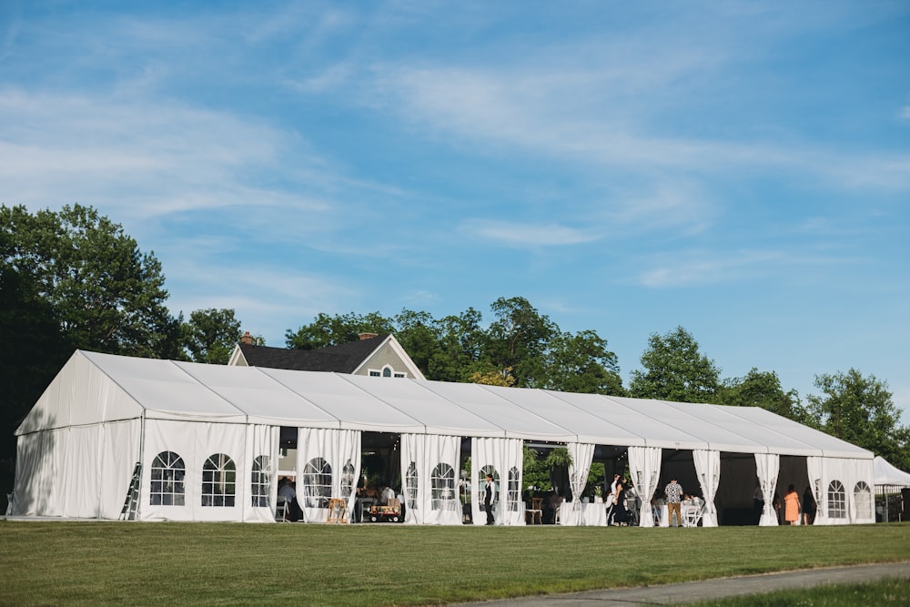 a large white tent set up for a wedding
