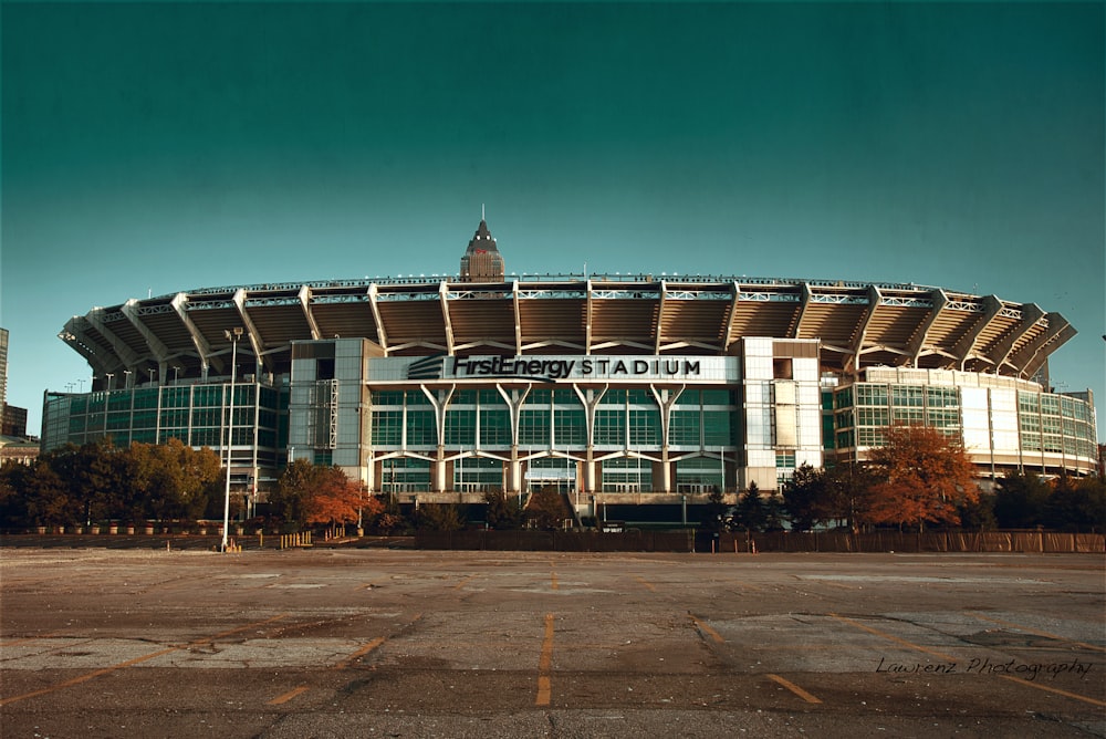 a large stadium building with a sky background