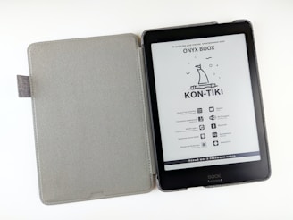 a kindle case with a book on top of it