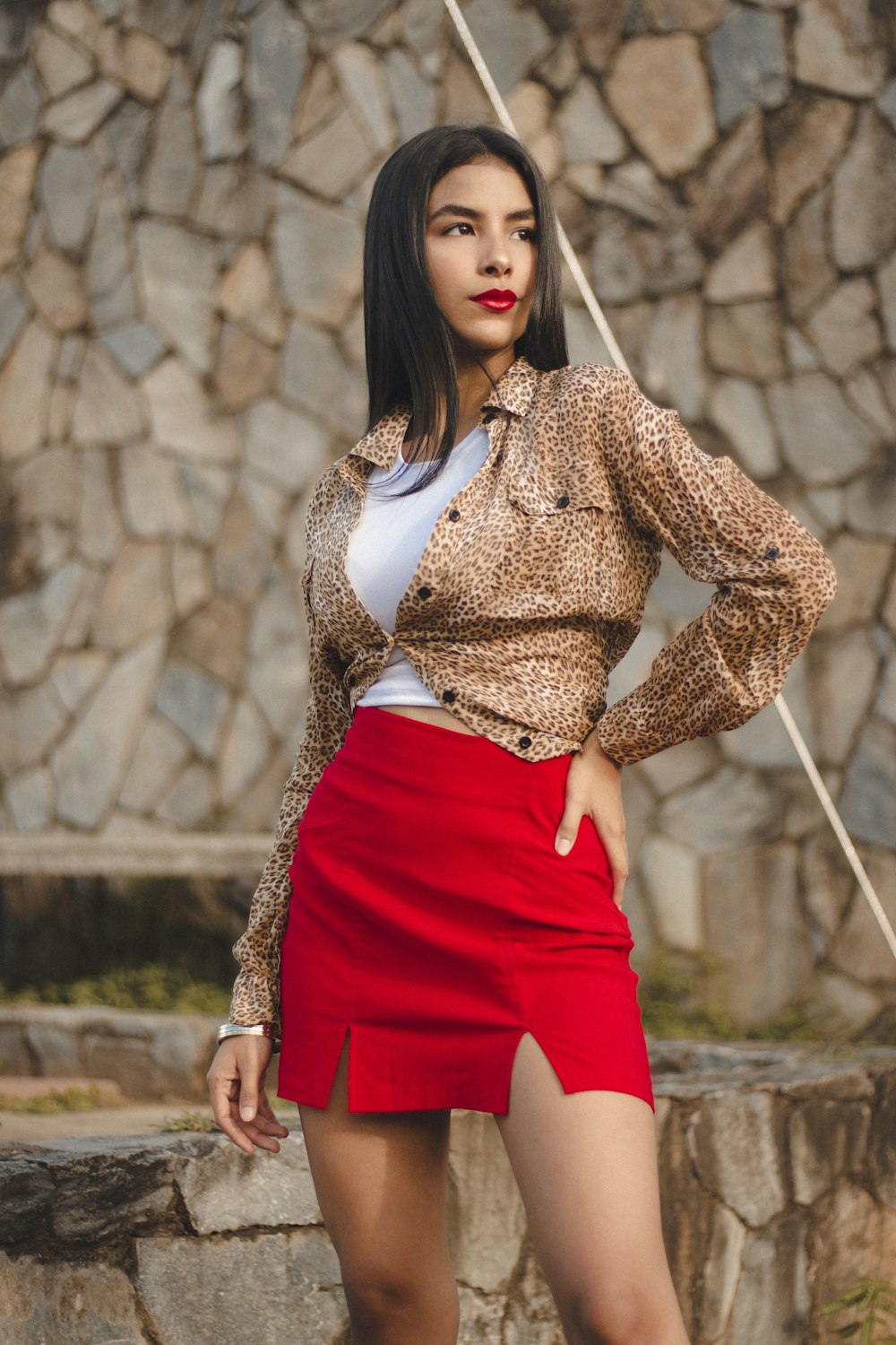 a woman in a red skirt posing for a picture