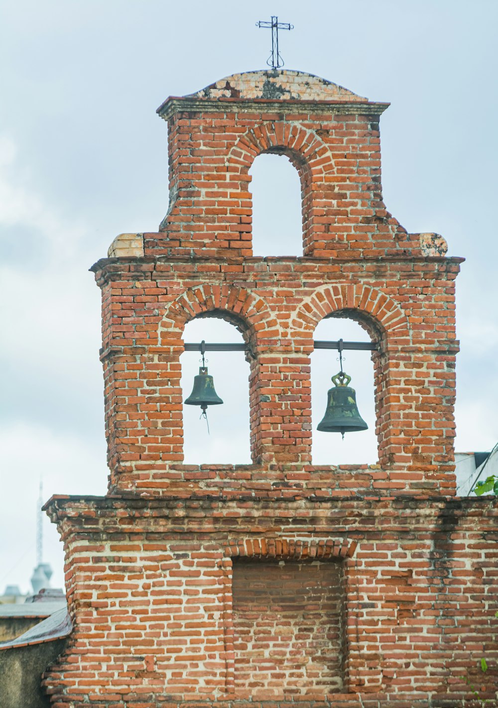 a bell tower with two bells on each of it's sides