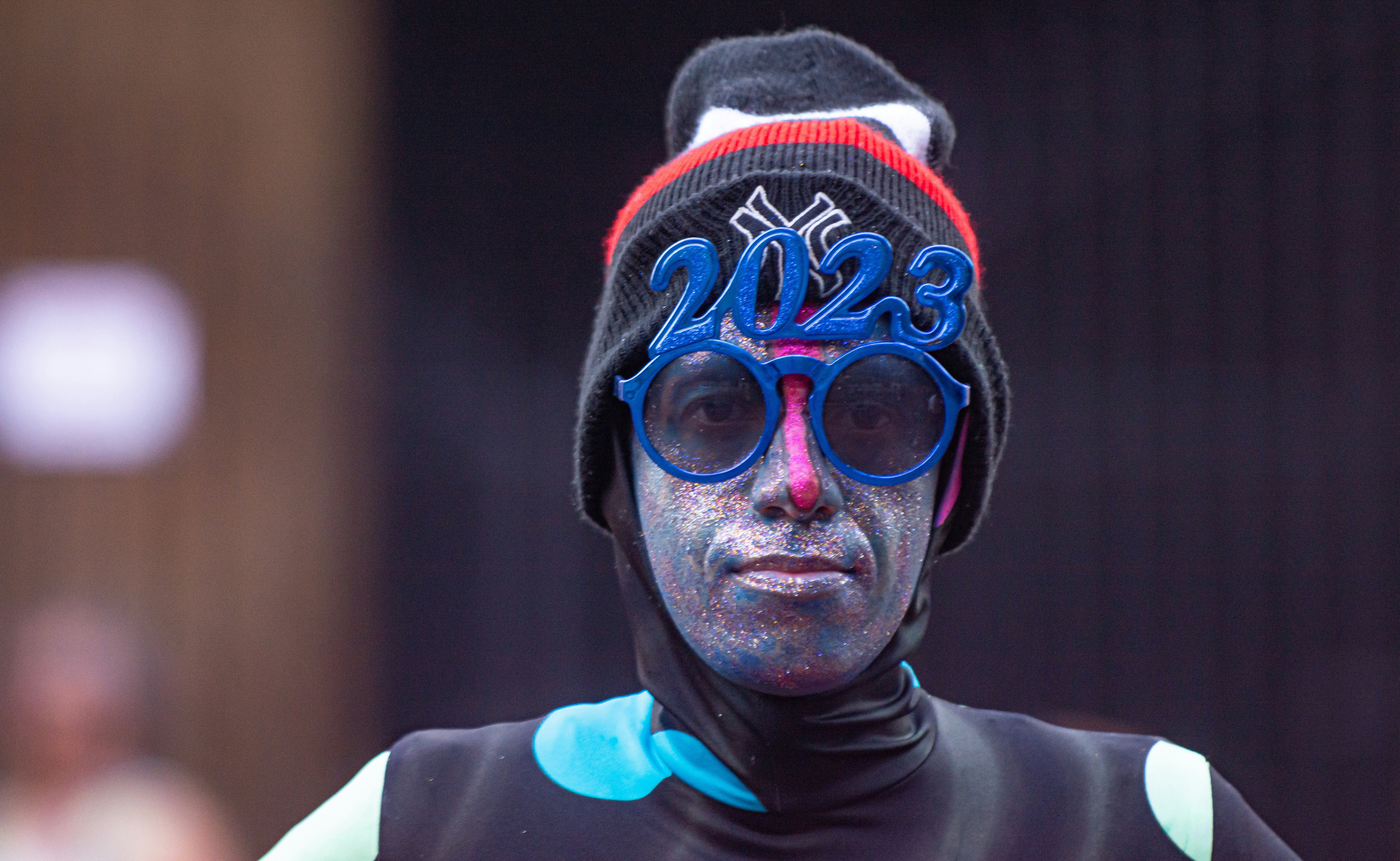 a man wearing a black and blue outfit and a hat