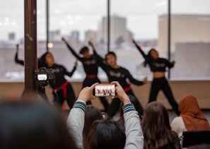 Wide-angle view of a dynamic dance sequence being filmed on an urban rooftop