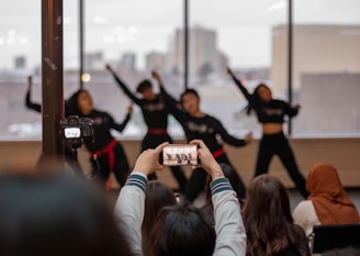 Wide-angle view of a dynamic dance sequence being filmed on an urban rooftop
