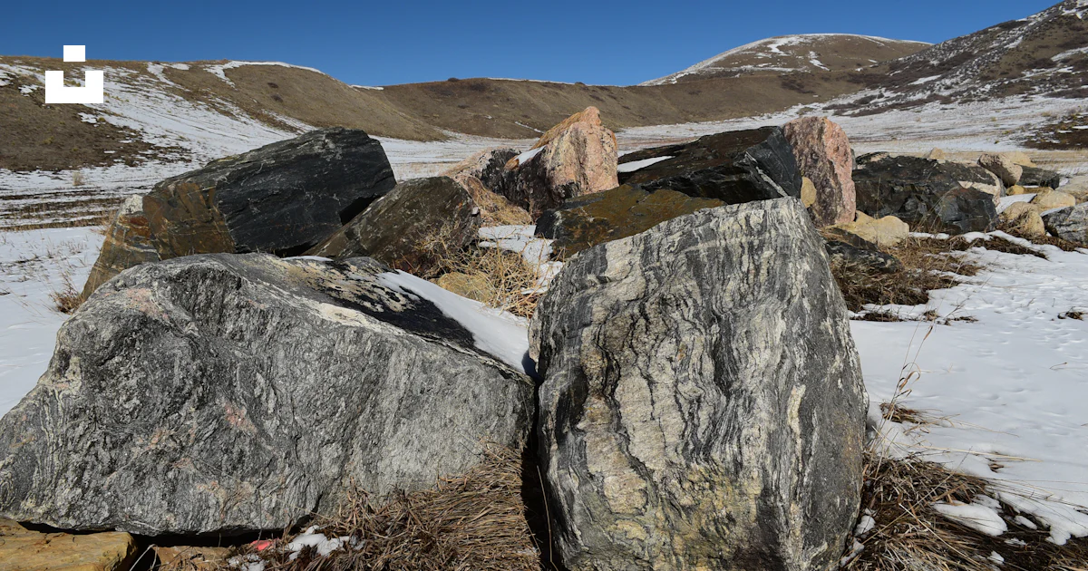 Snow Rocks Ground A group of rocks sitting on top of a snow covered ground photo – Free ...