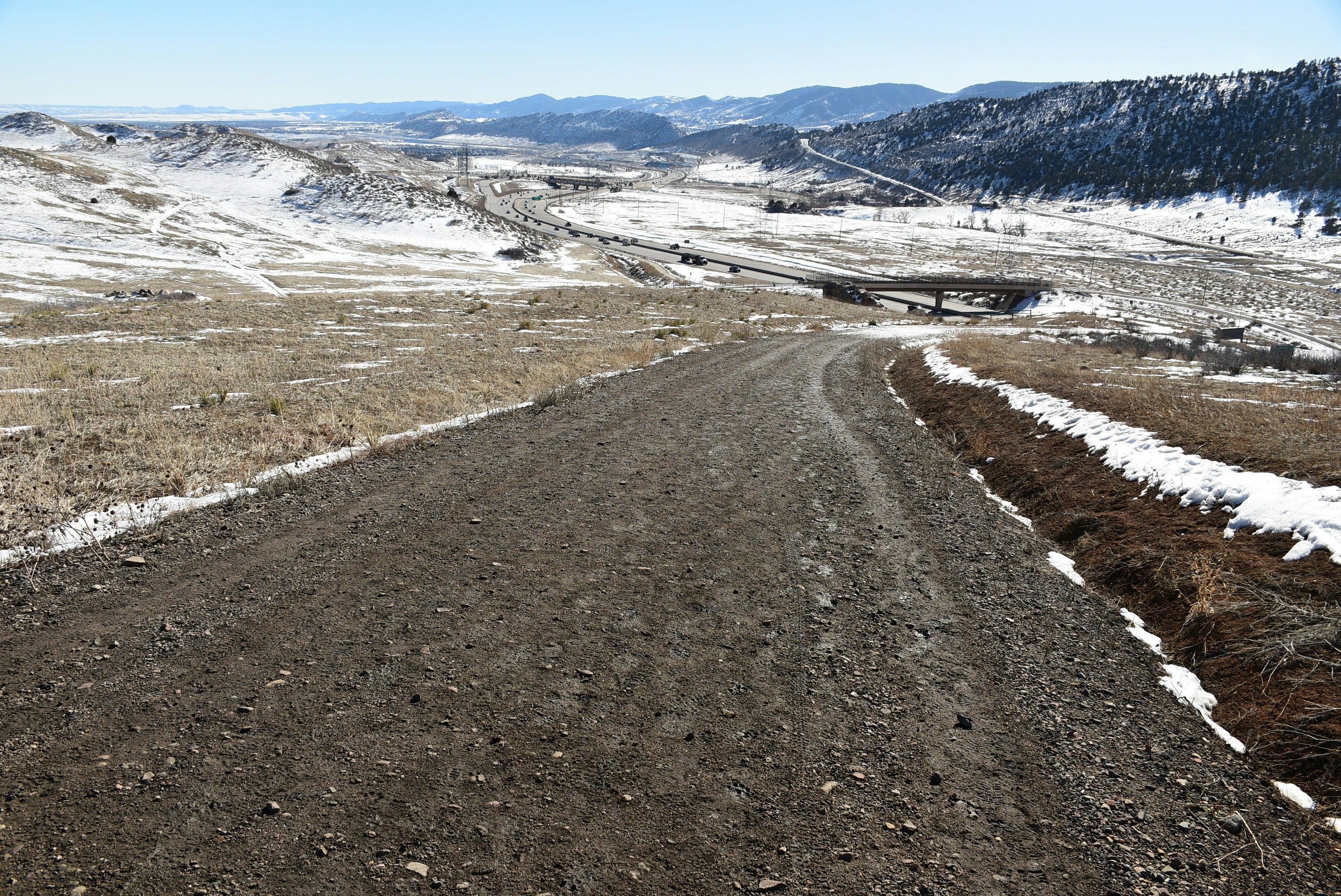 a dirt road surrounded by snow covered mountains, Rooney Road Trailhead, Morrison, CO