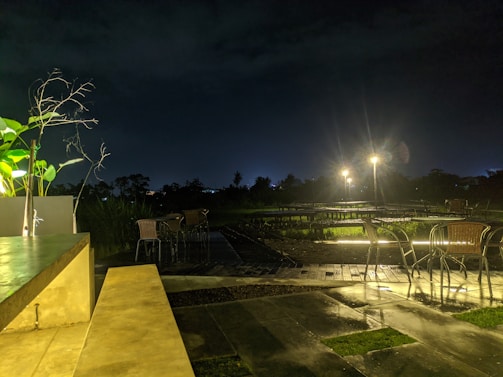 Outdoor patio featuring textured stone-like resin flooring under warm evening lighting.