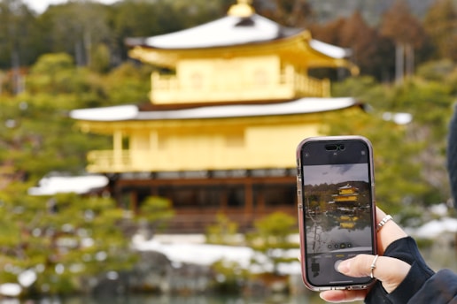 a person taking a picture of a building with a cell phone