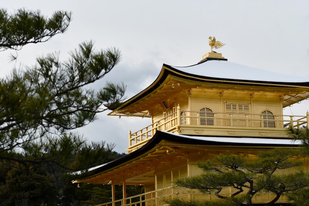 a tall yellow building with a gold roof