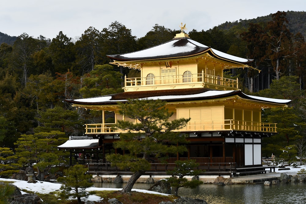 a yellow building sitting on top of a body of water