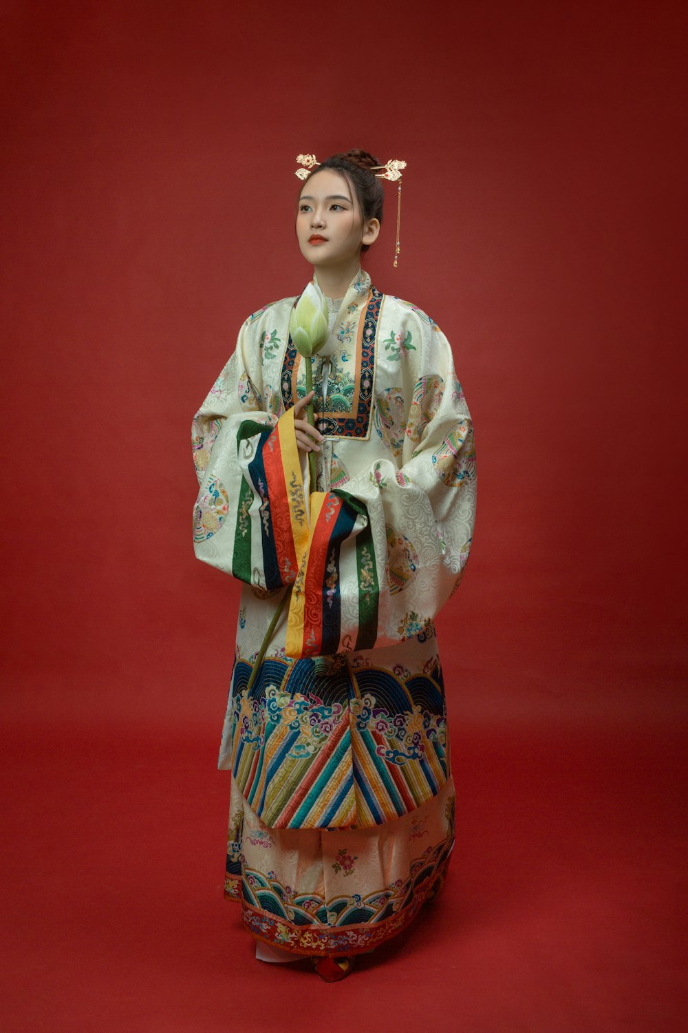 a statue of a woman with a flower in her hand