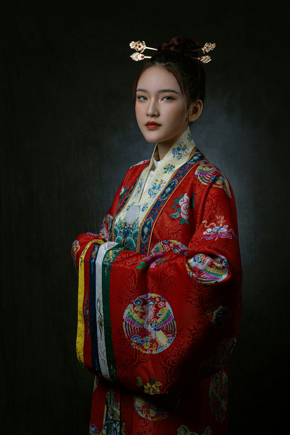 a woman in a red kimono is posing for a picture